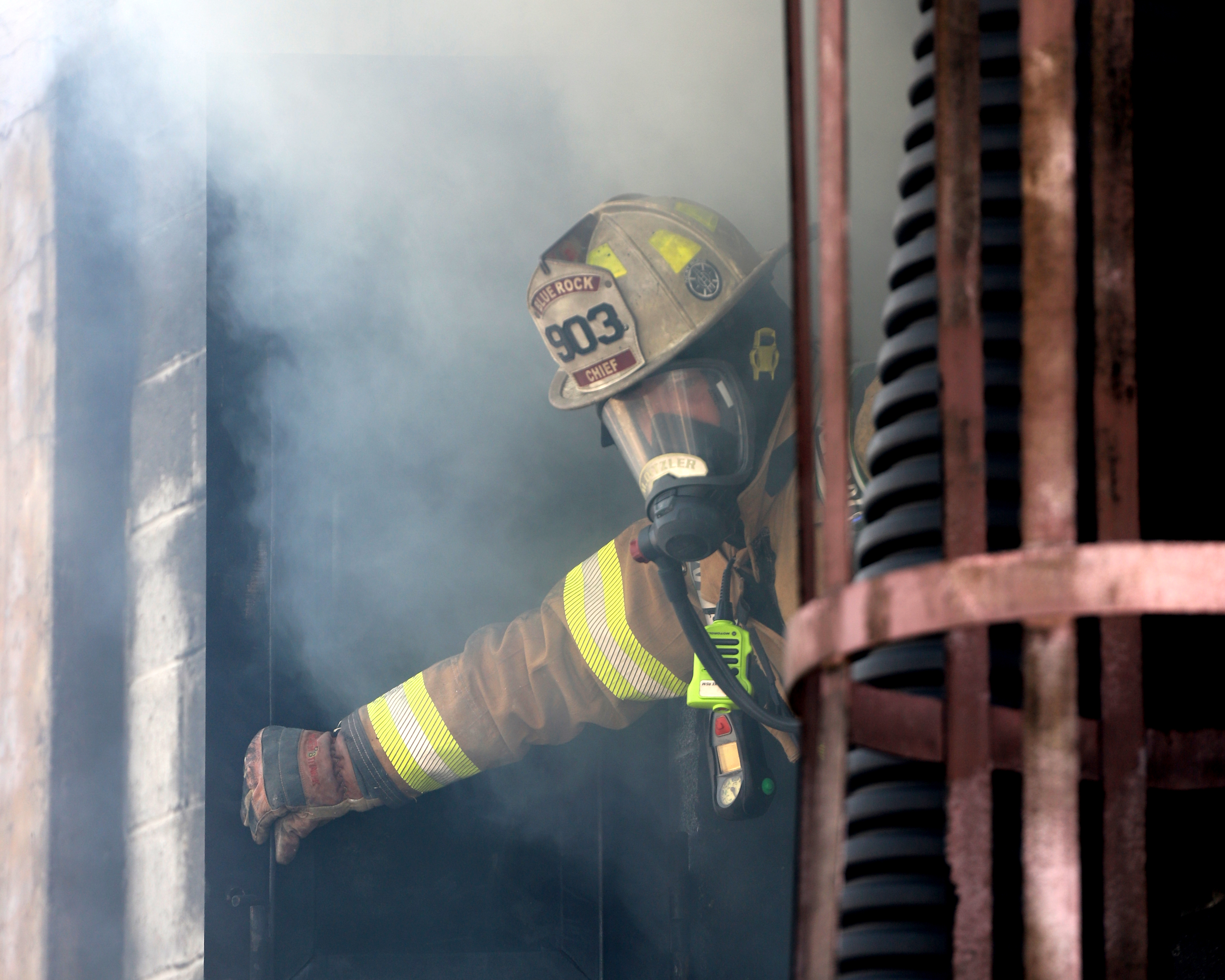 Firefighter standing in front of smoke